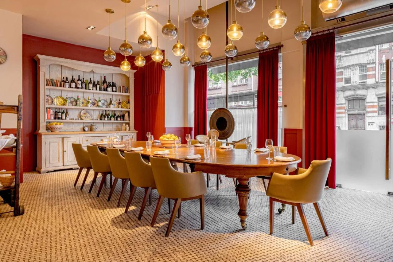 a dining room with a wooden table and chairs at Park Plaza London Victoria in London