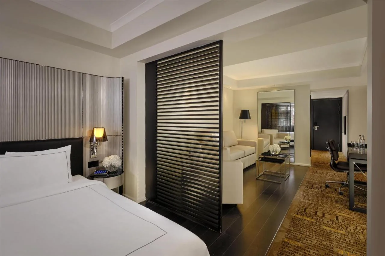 a bedroom with a bed and a living room at Park Plaza London Victoria in London